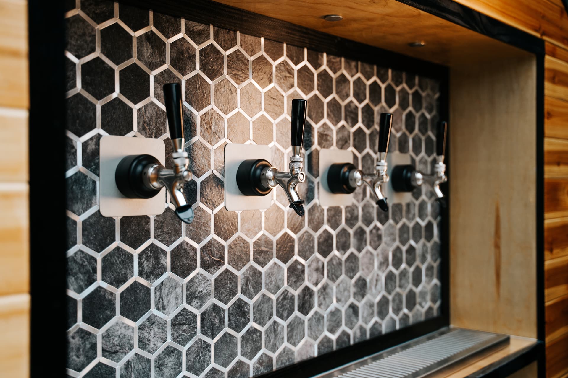 Chrome taps against the hex backsplash